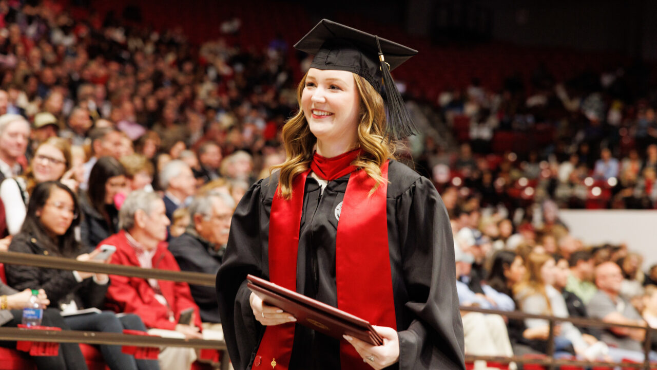 a young woman smiles after getting her degree