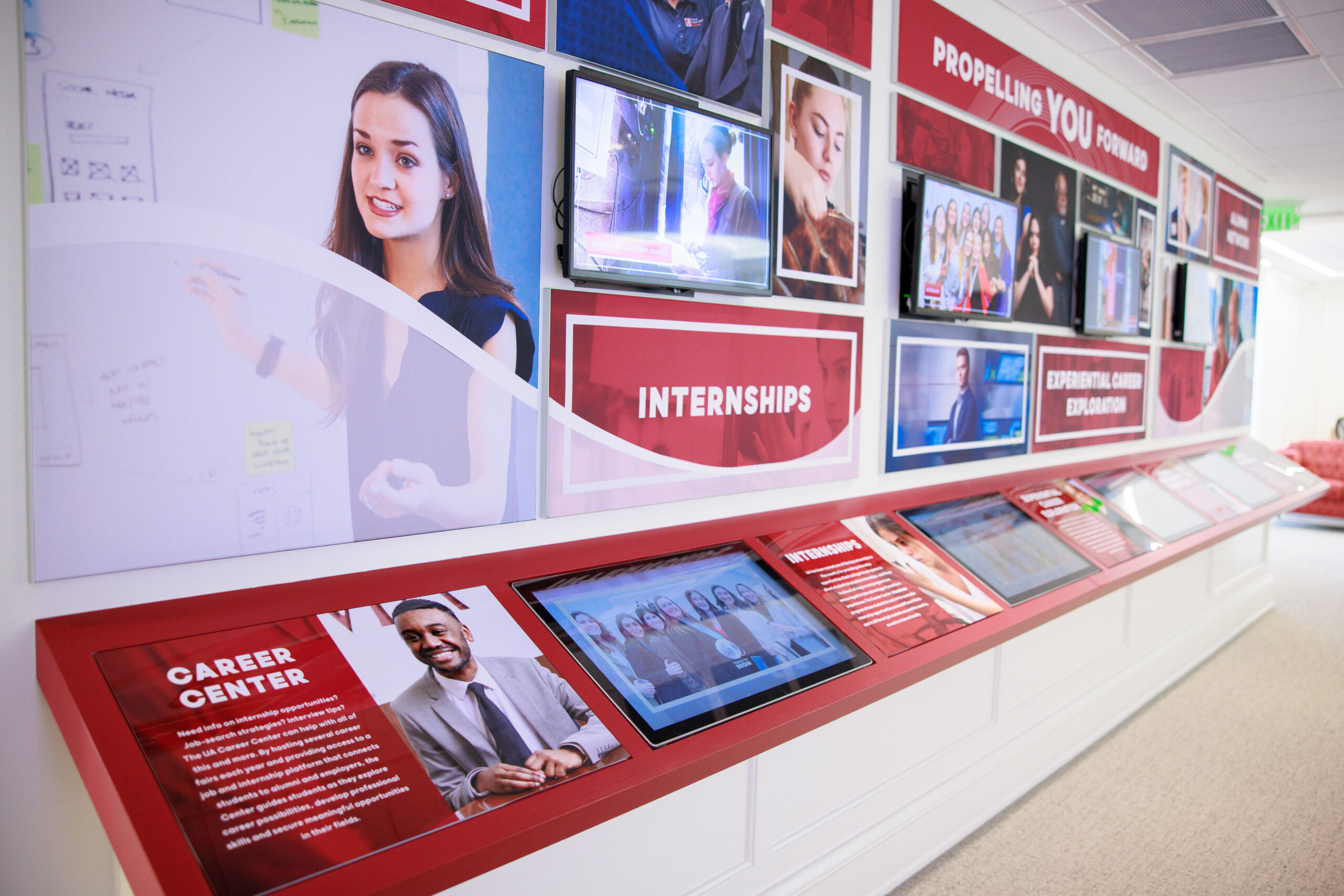 a museum-like exhibit featuring pictures of real UA students