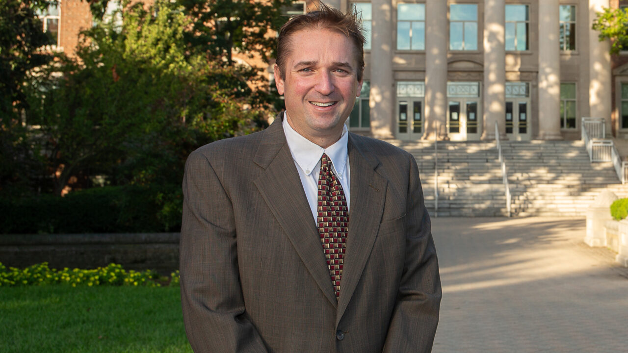 Bryan Boudouris standing in front of a university building