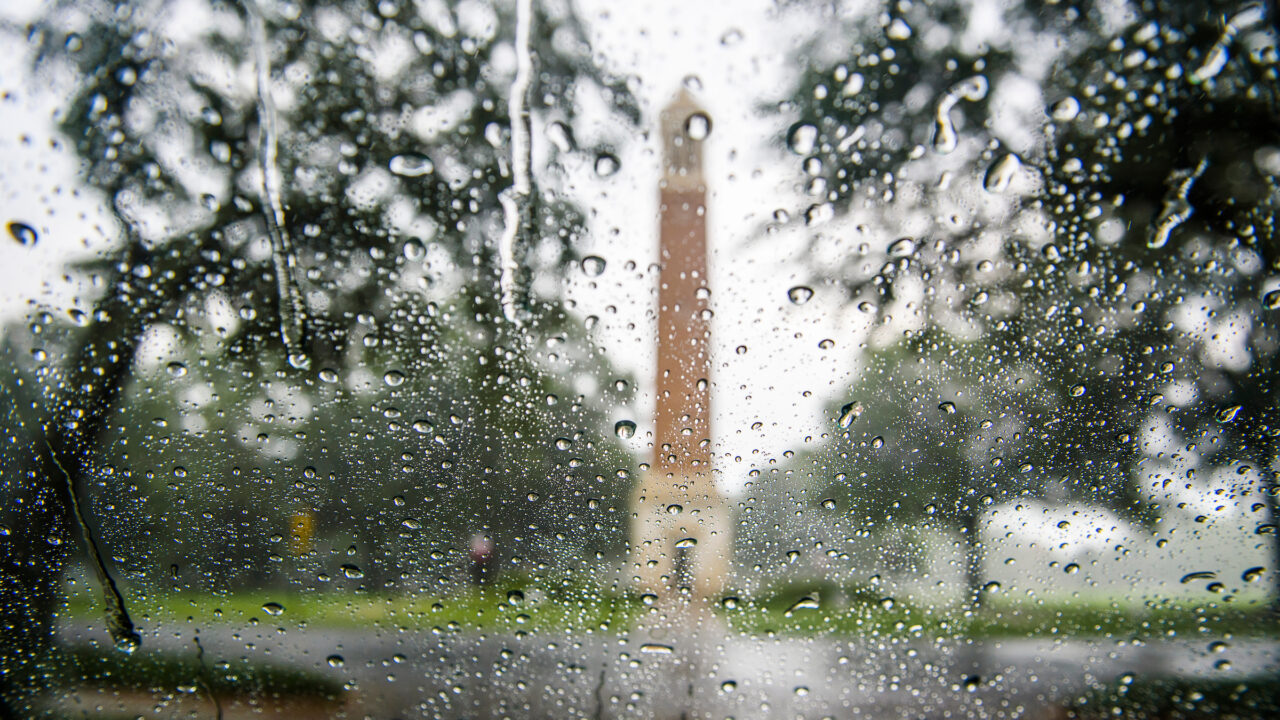 Denny Chimes as seen through a car's windshield with rain on it.