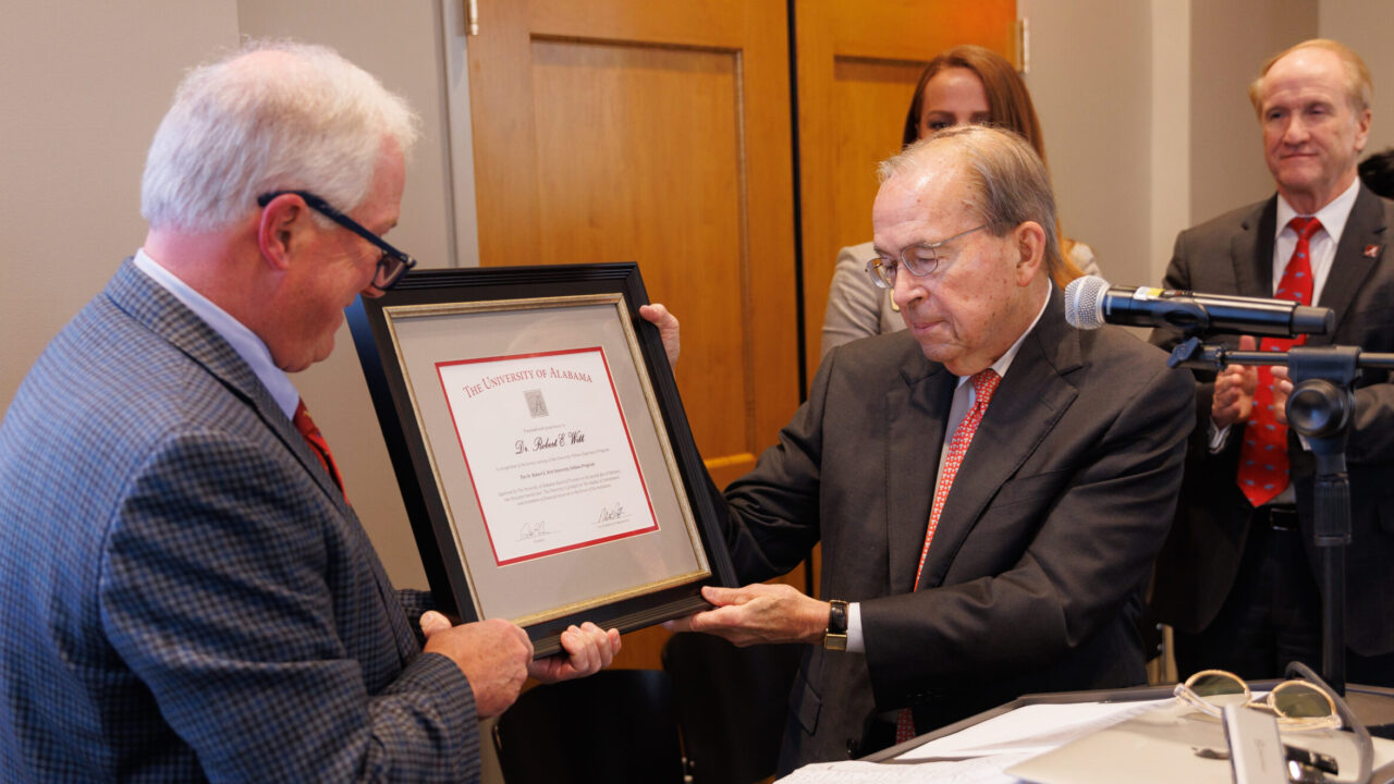 President Emeritus Robert Witt receiving a plaque from Dr. Allen Yeilding in honor of the renaming of the UA Fellows Program