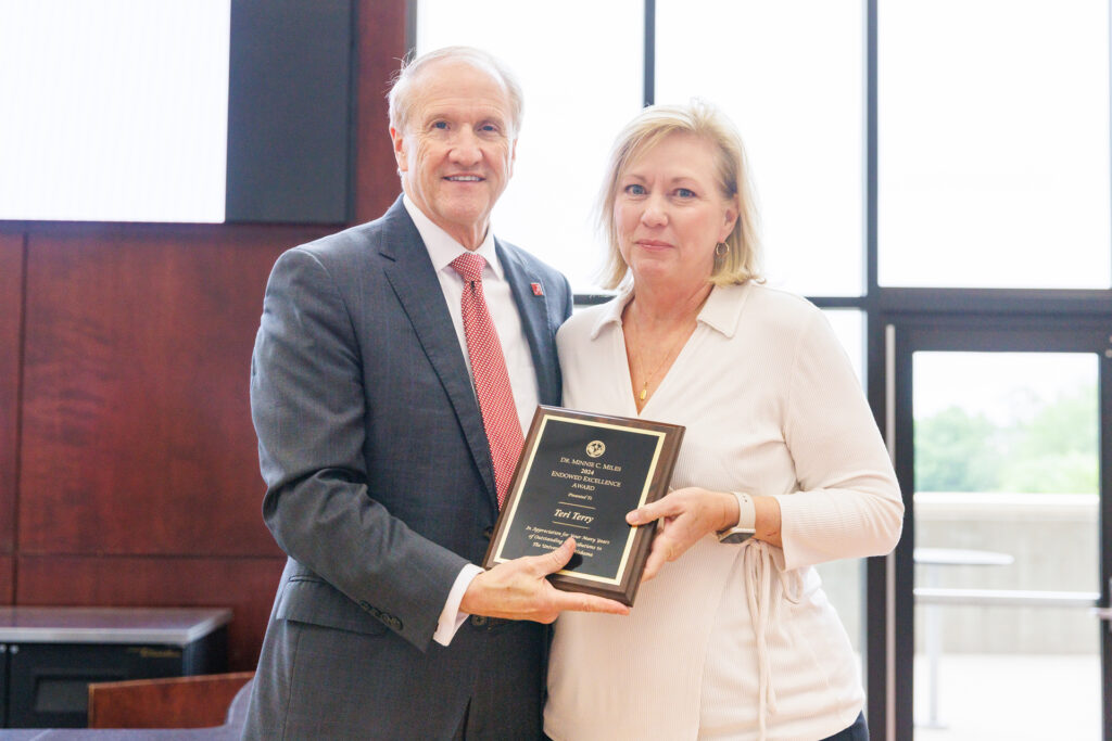 Dr. Bell with Teri Terry, holding her award