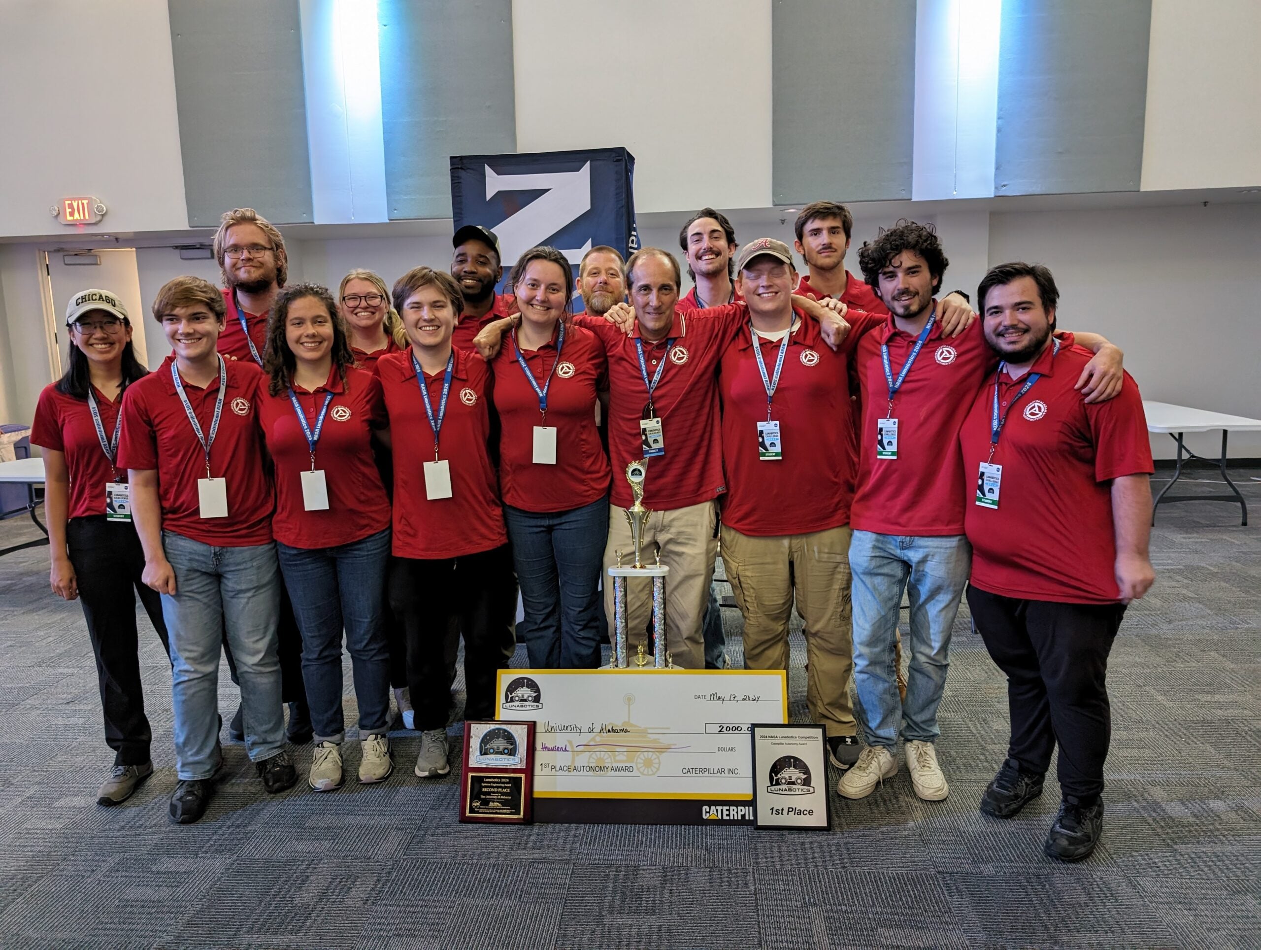 UA Astrobotics team at the NASA Lunabotics competition with their awards and trophy.