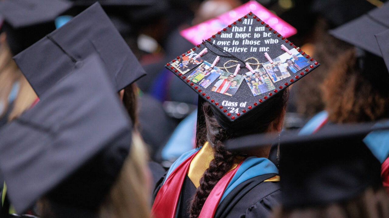 the back of a commencement cap on a graduate's head that reads "all that I am or hope to be I owe to those who believe in me."