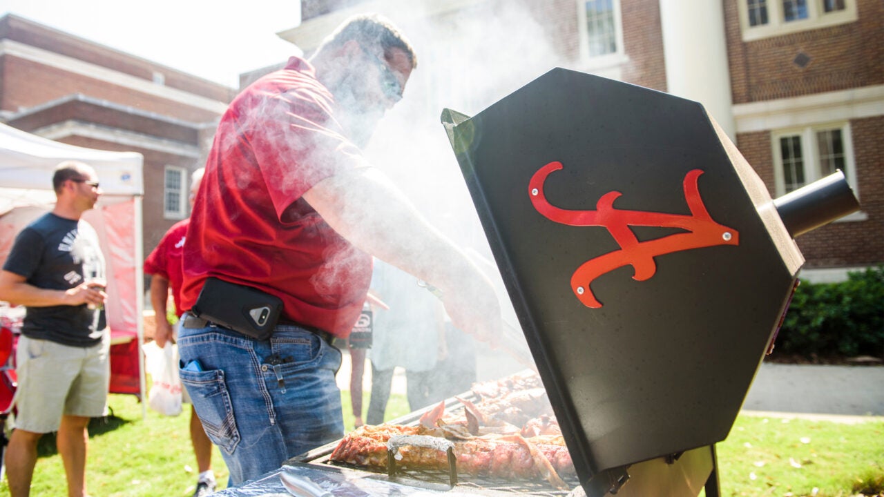 A man grilling food.