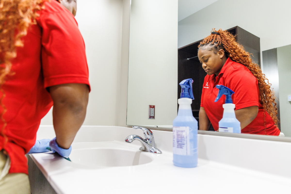 U A facilities staff cleaning dorm room as part of summer housing turnover