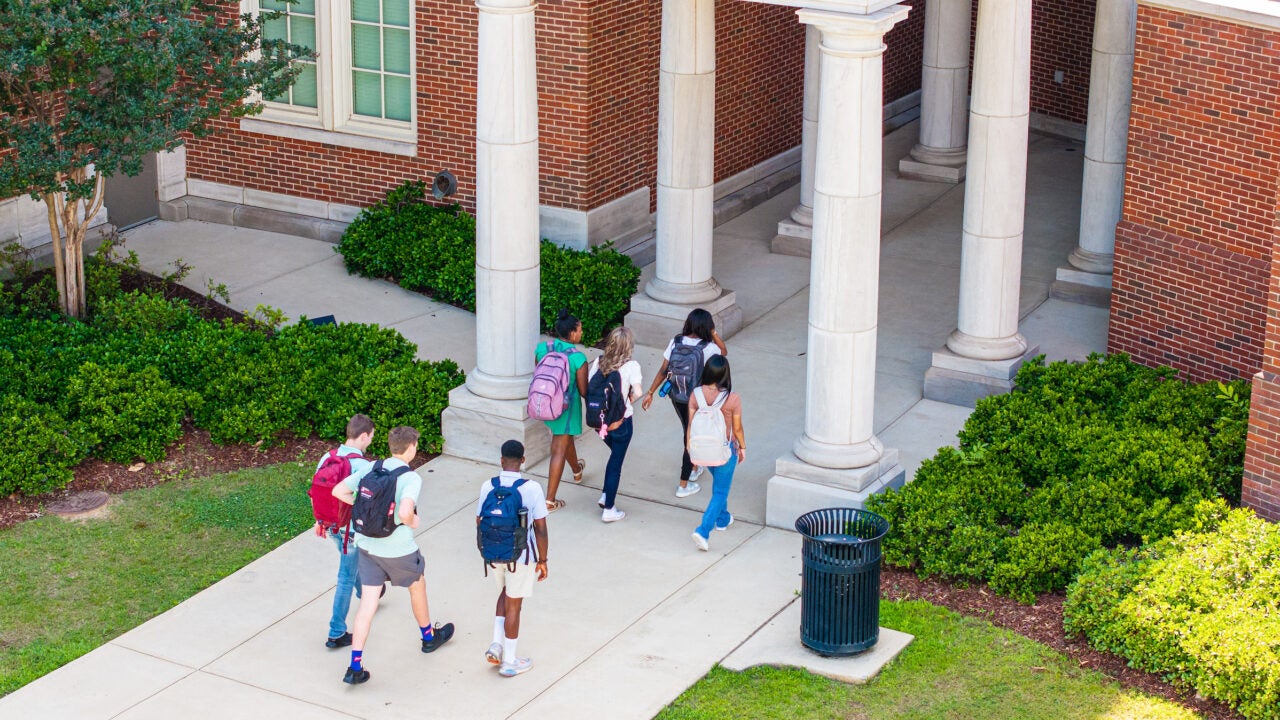 a view from above of students entering a class building