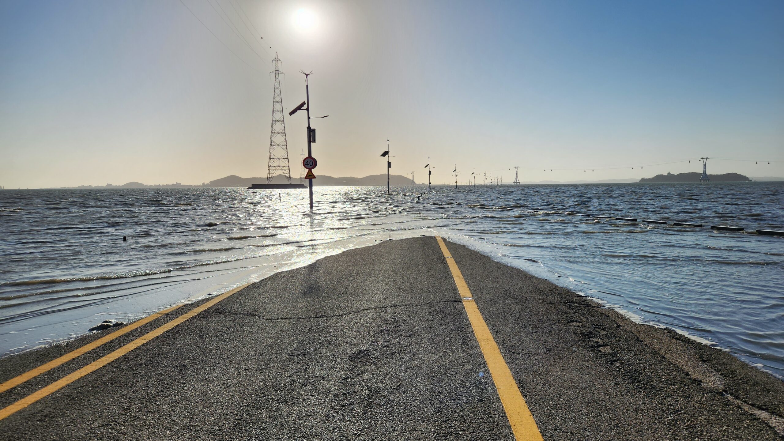 The view of a road submerged in the sea at high tide