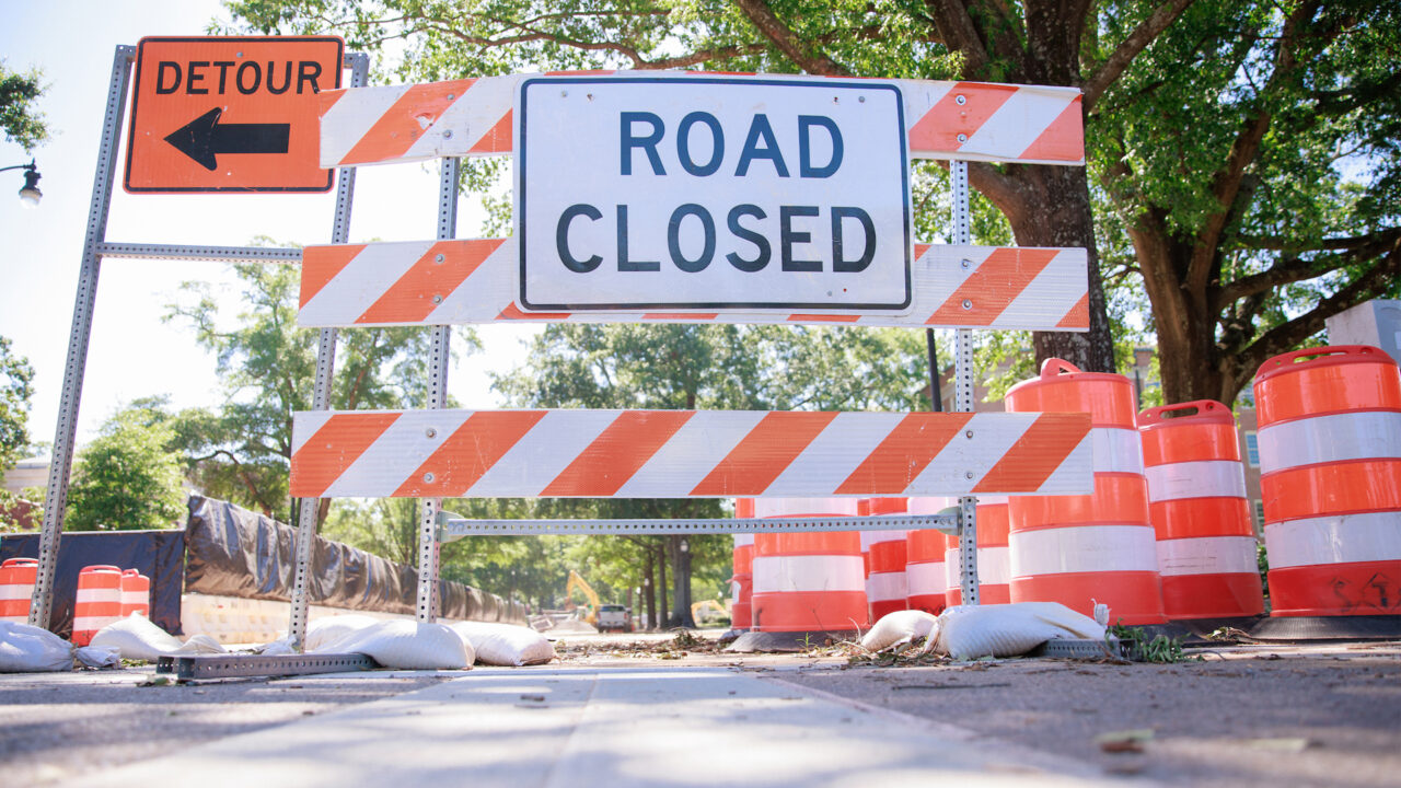 Road closed and detour signs on campus