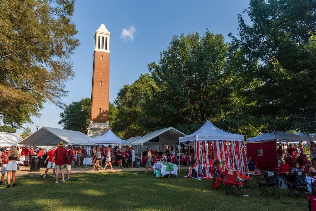 Football fans tailgate before an Alabama football game.