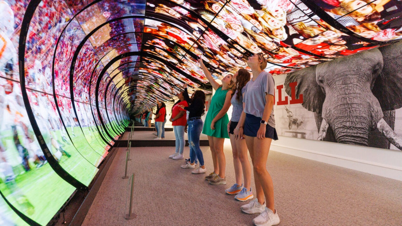 Students view the dynamic Roll Tide room at the Randall Welcome Center