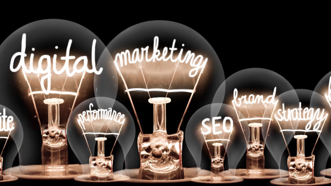 Photo of light bulbs with shining fibers in a shape of Digital Marketing, Website, SEO and Strategy concept related words isolated on black background