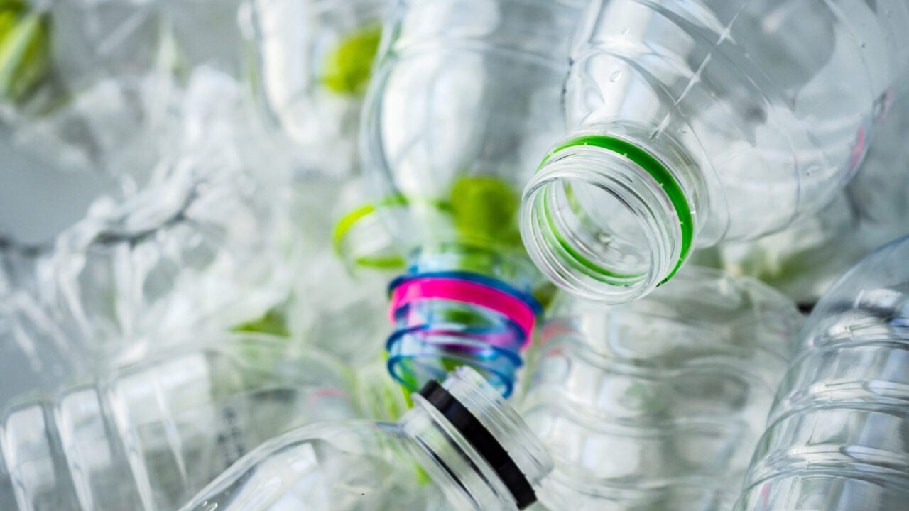 Several clear plastic bottles with the lids removed.