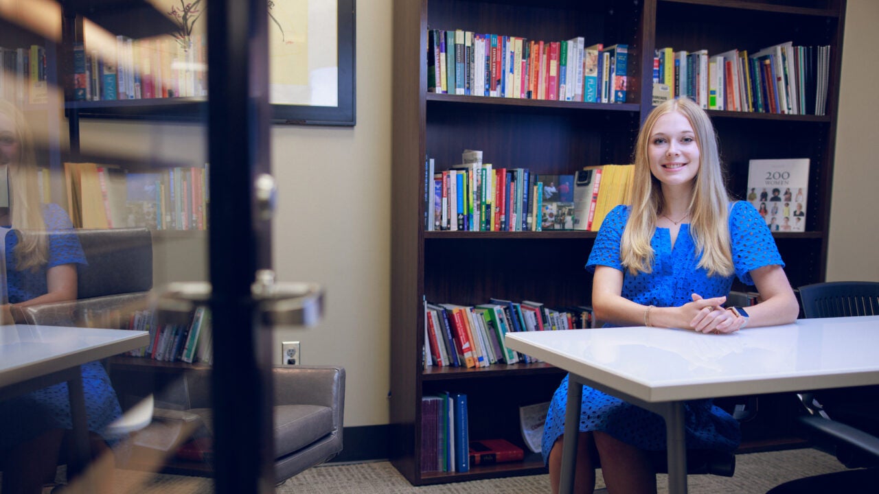 Emily Adcock sits at a table