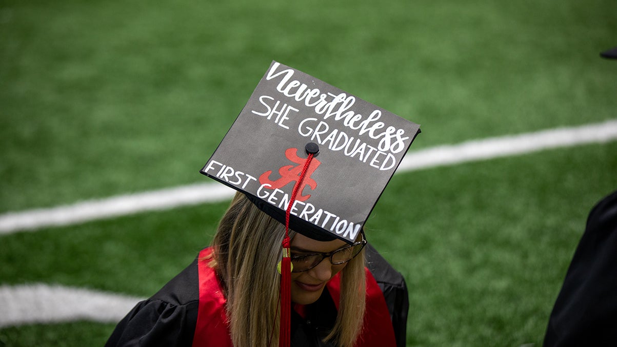 A graduating student wears a decorated mortar board.