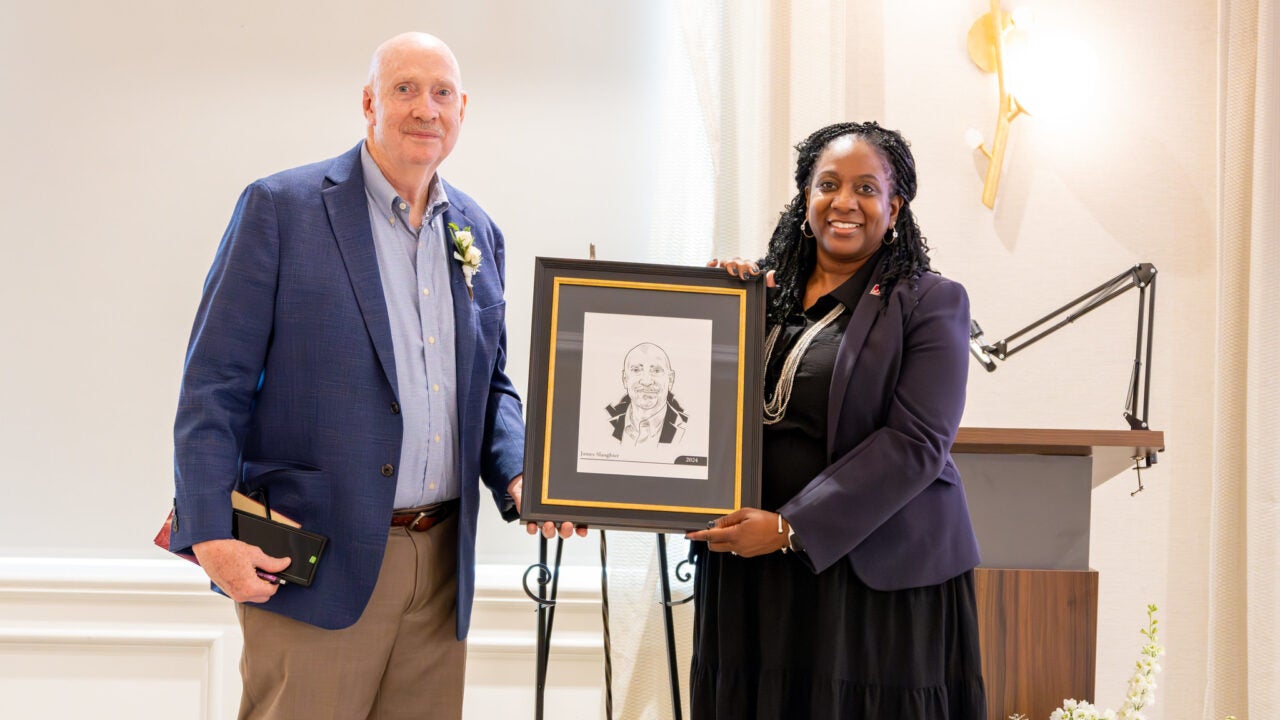 Dean Schnavia Smith Hatcher presentes a portrait to James Slaughter, the 2024 social work hall of fame inductee