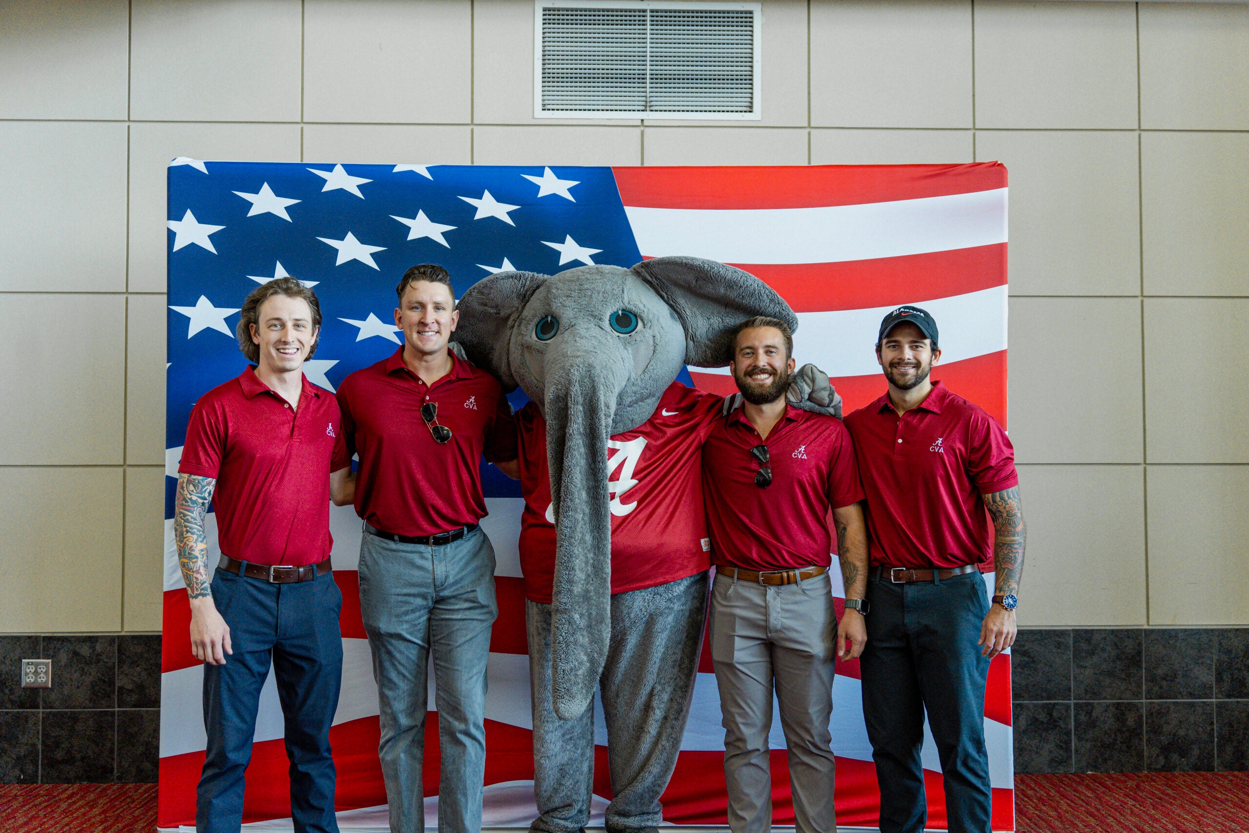 four men in red shirts pose with Big Al