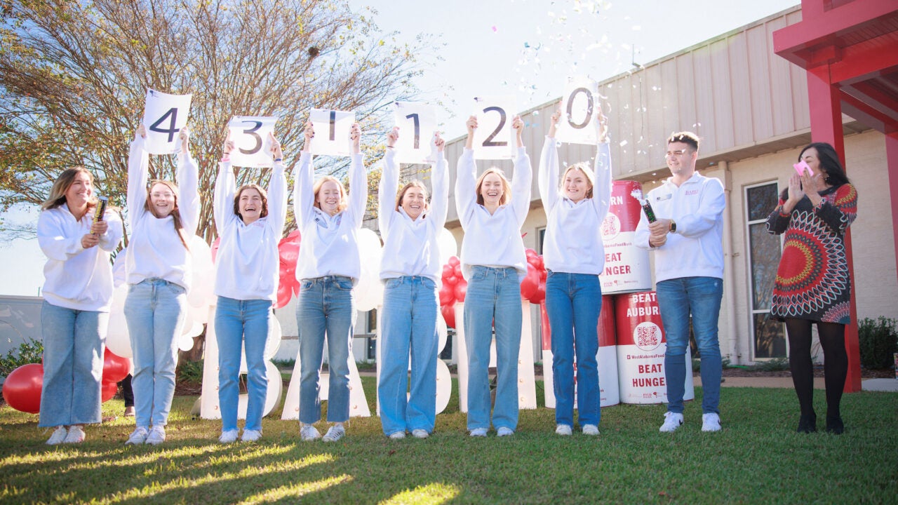 A group of students hold up numbers.