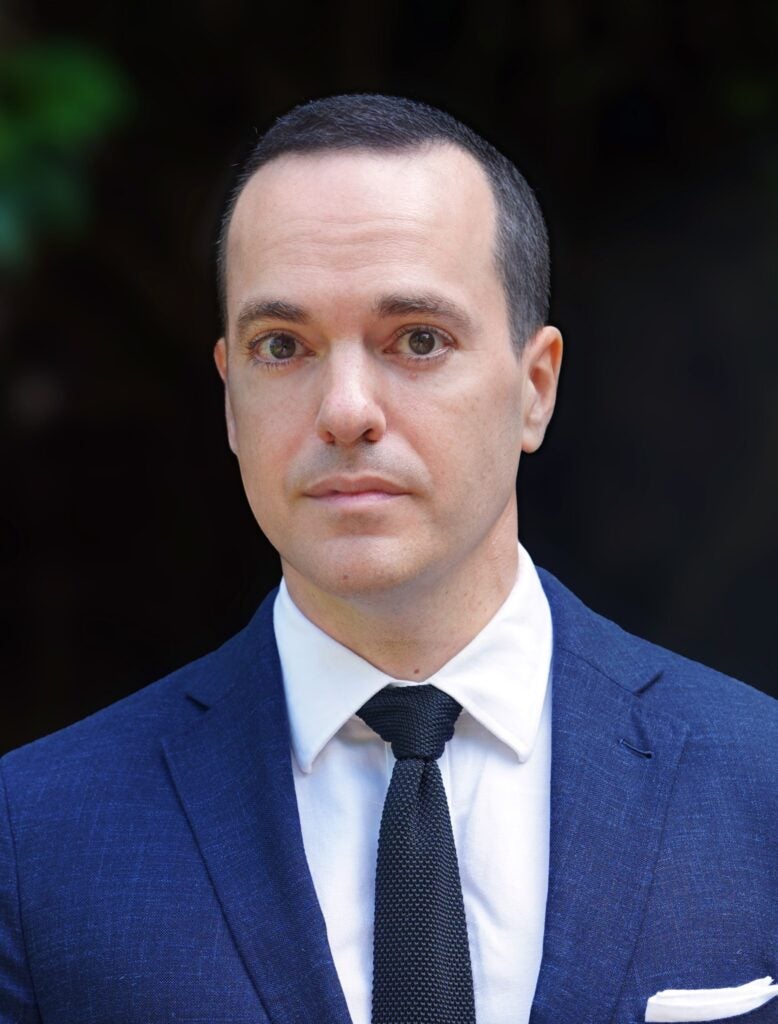 Headshot of Dr. Lawrence Cappello in a blue suit with a navy tie and a white pocket square. helped develop a generative AI teaching workshop for faculty.