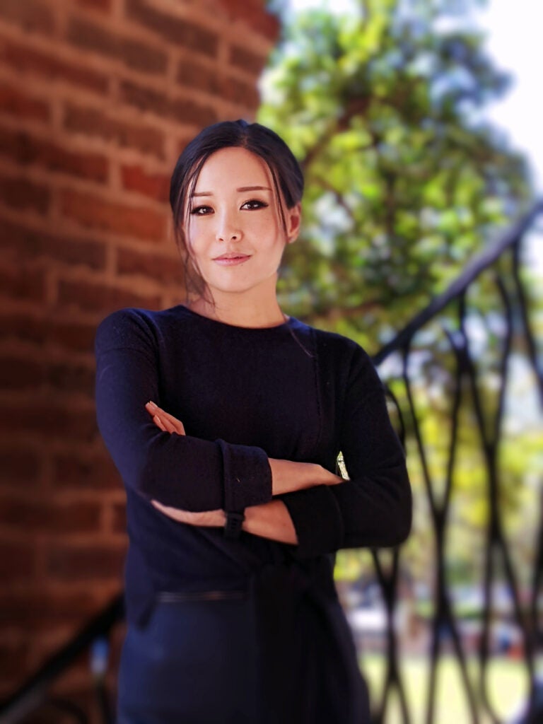 Dr. Katherine Chiou stands in front of a brick wall with her arms crossed. Chiou helped develop a generative AI teaching workshop for faculty. 