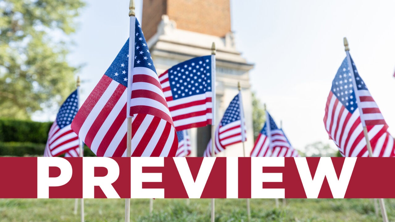 Small American flags in front of Denny Chimes