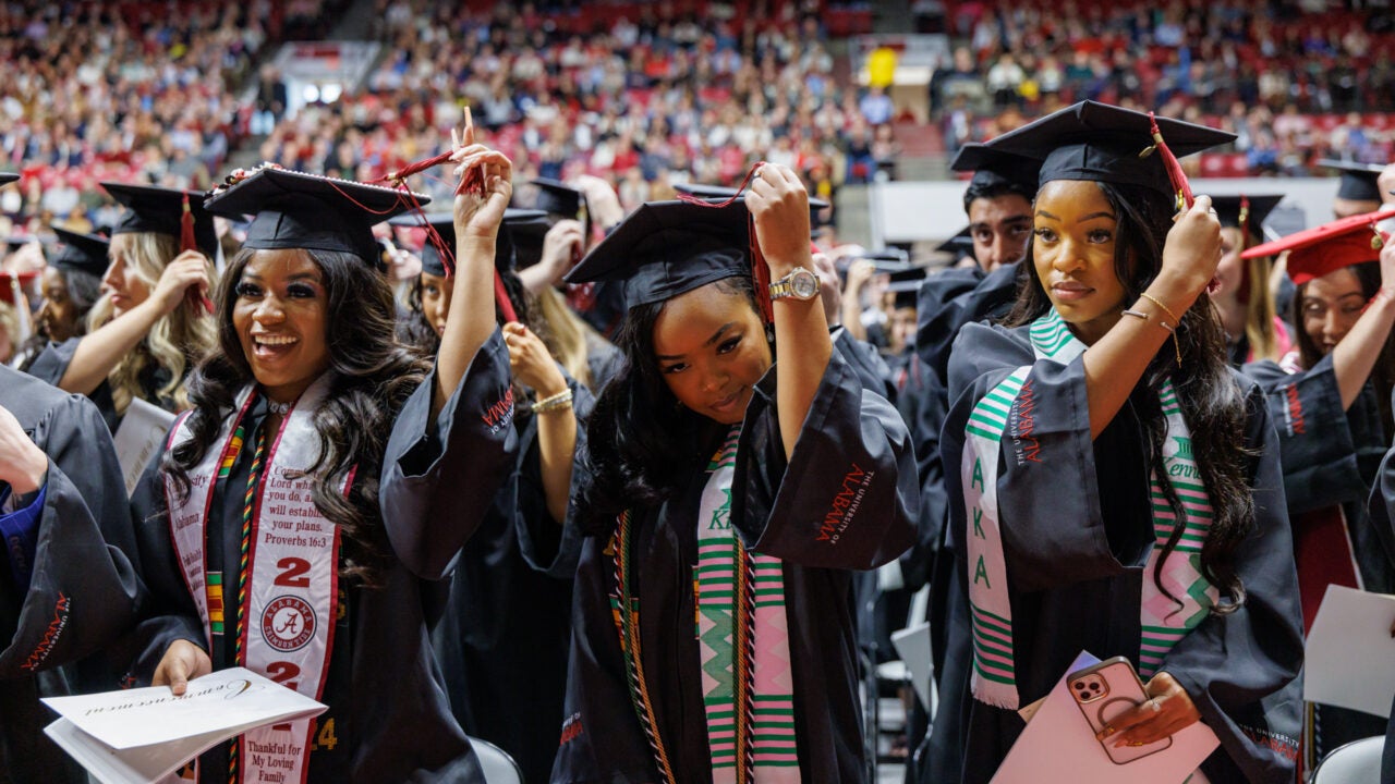 three young women move their tassels