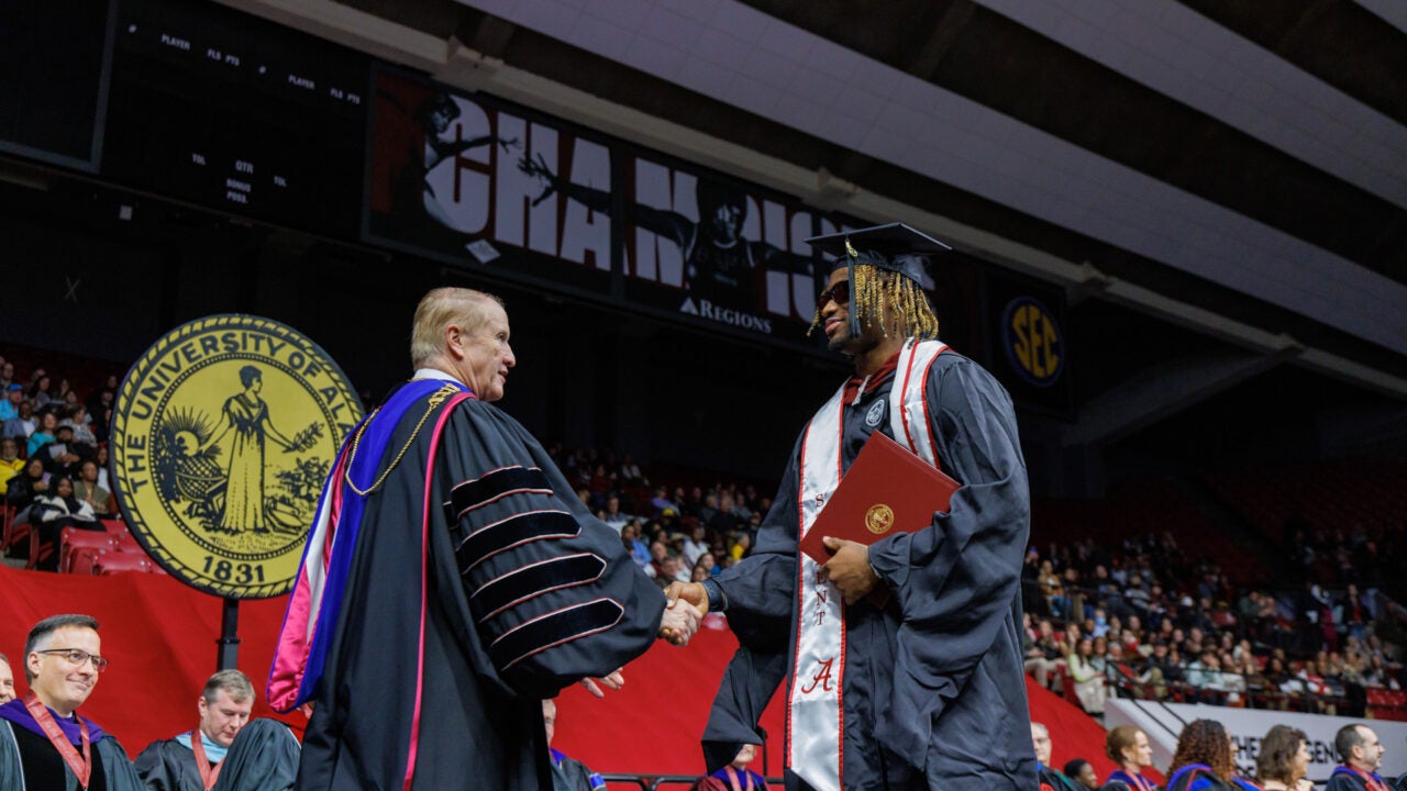 jalen Milroe shakes Dr. Bell's hand on the commencement stage