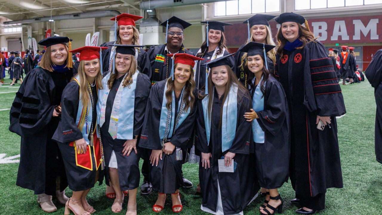 a large group of students pose for a photo in the staging area.