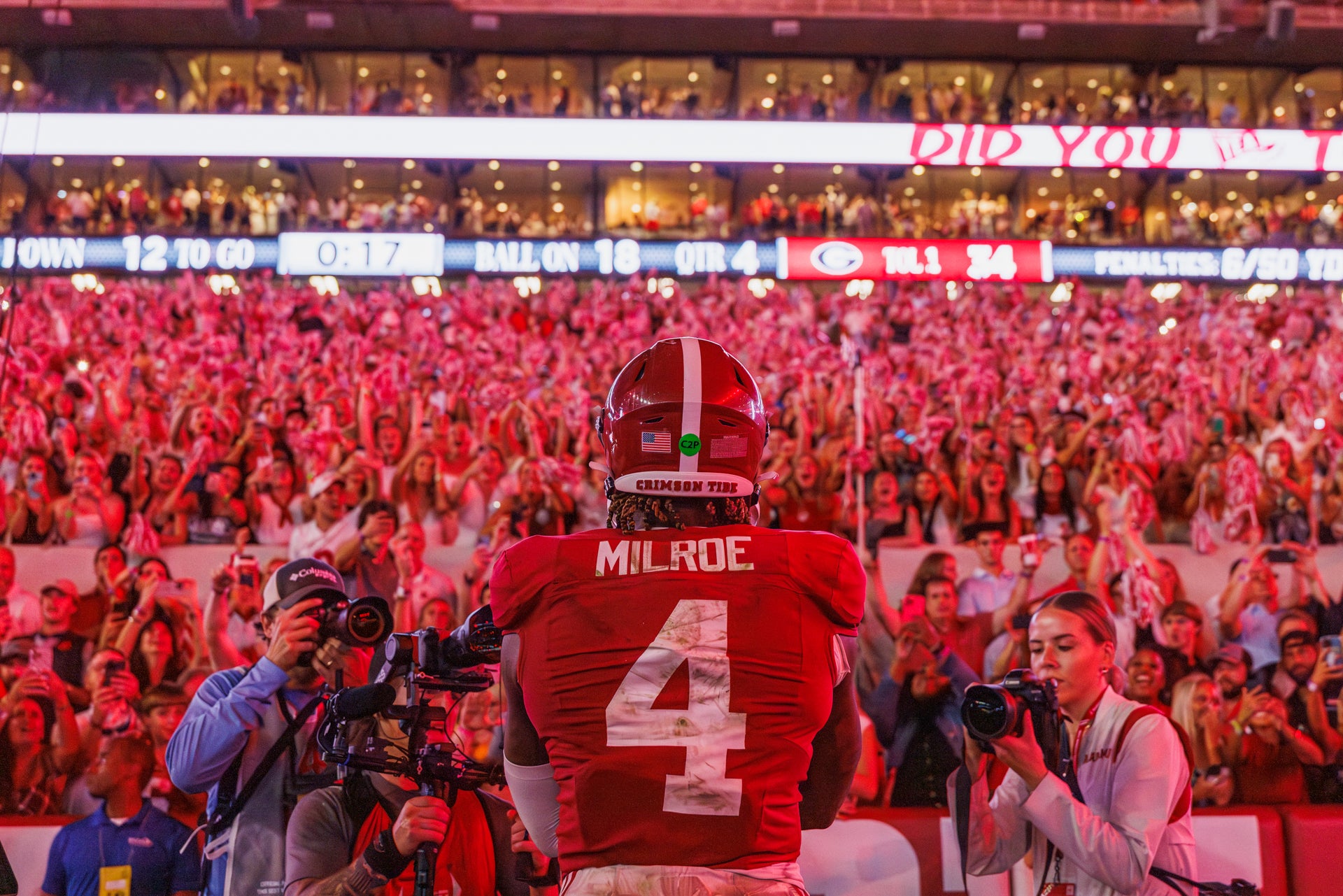 a show of Jalen milroe's back as he soaks up the crowd's energy after defeating UGA