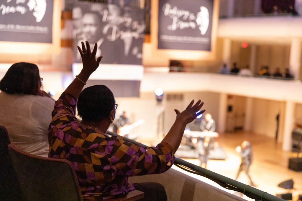 a women waves her arms during a concert