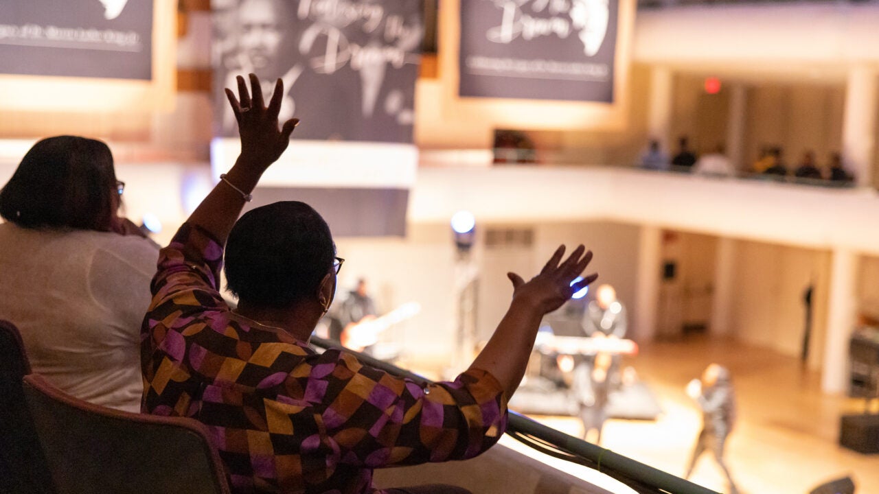 a women waves her arms during a concert