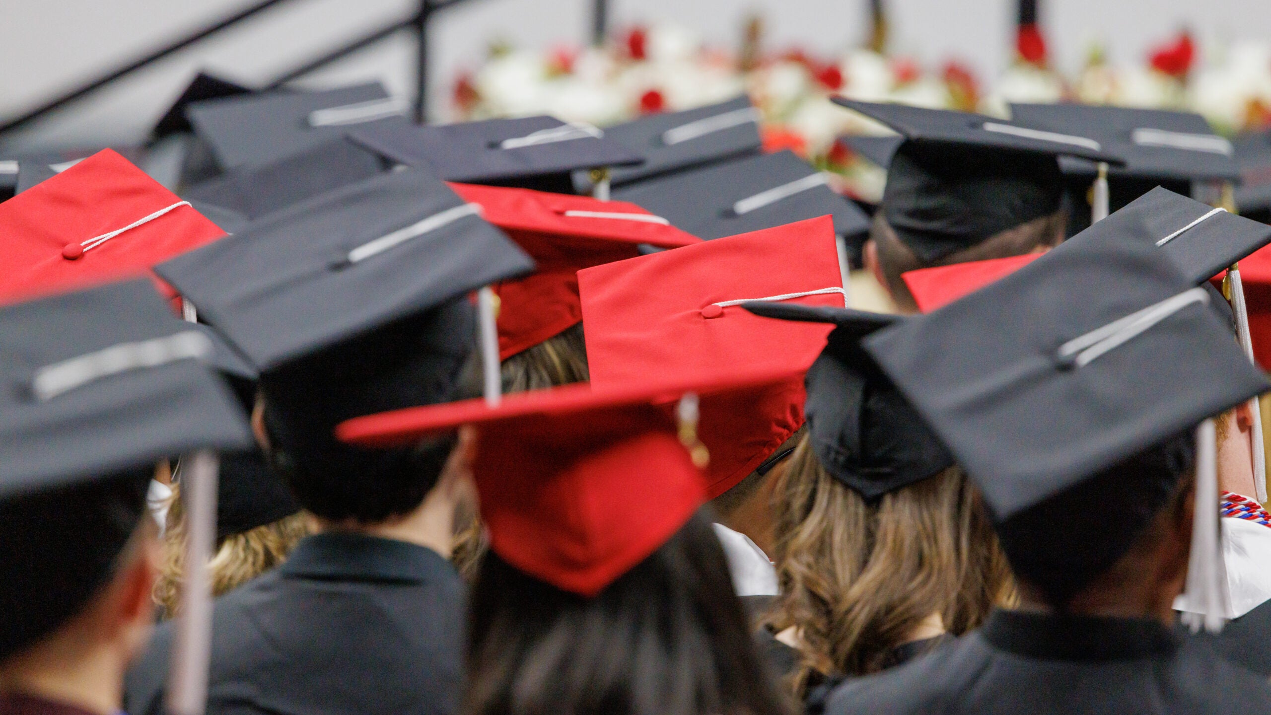 A group of graduation caps at a commencement ceremony