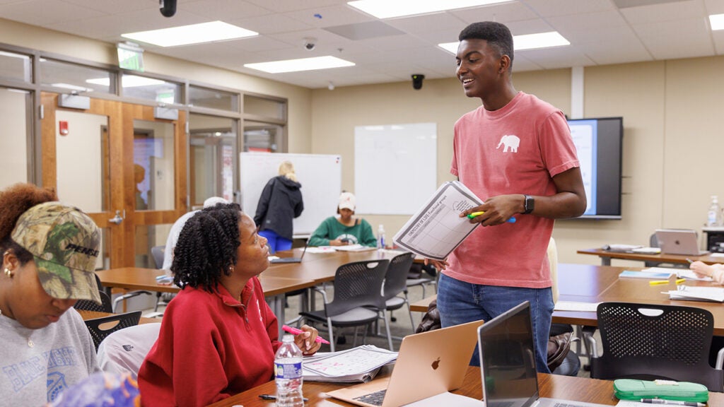 Malik Cooper talks with a student during one of his Supplemental Instruction sessions.