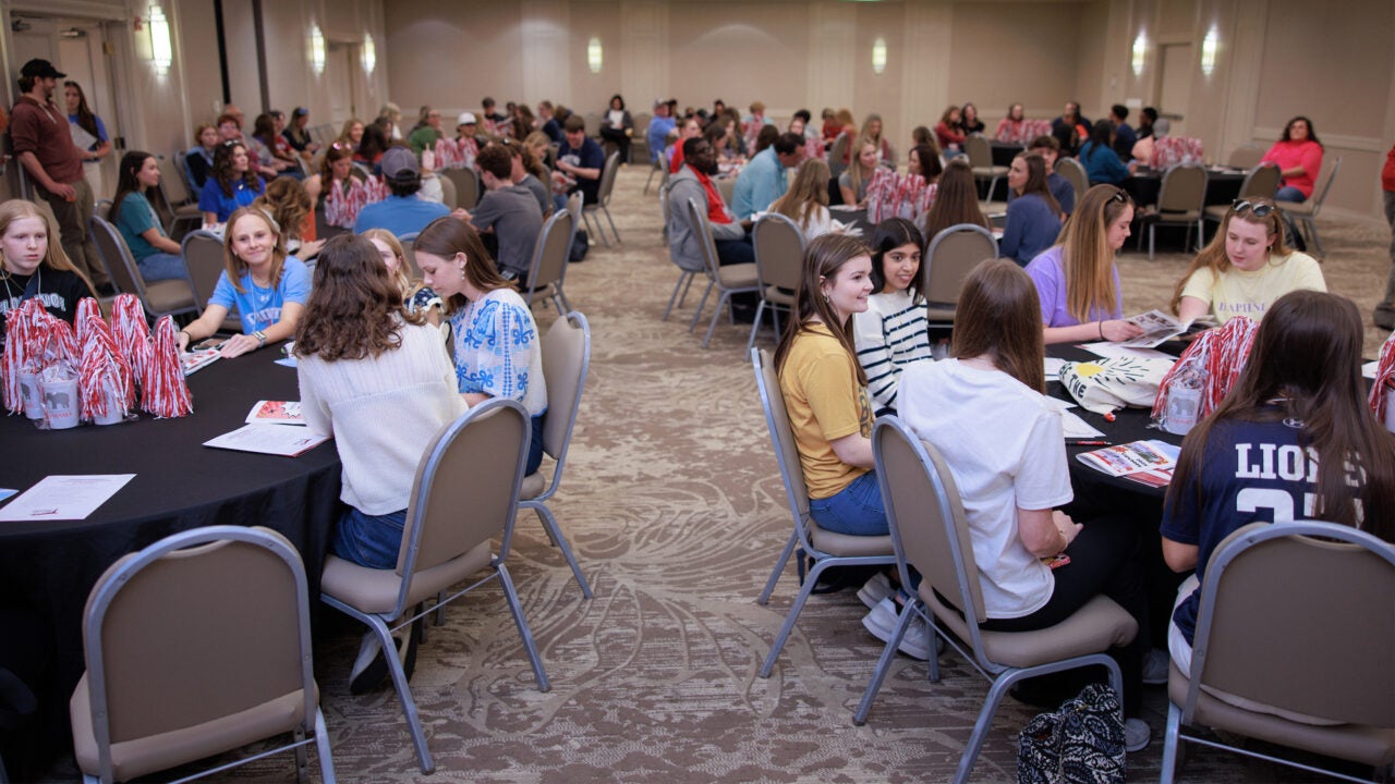 Several tables of Capstone Leadership Academy participants getting to know each other