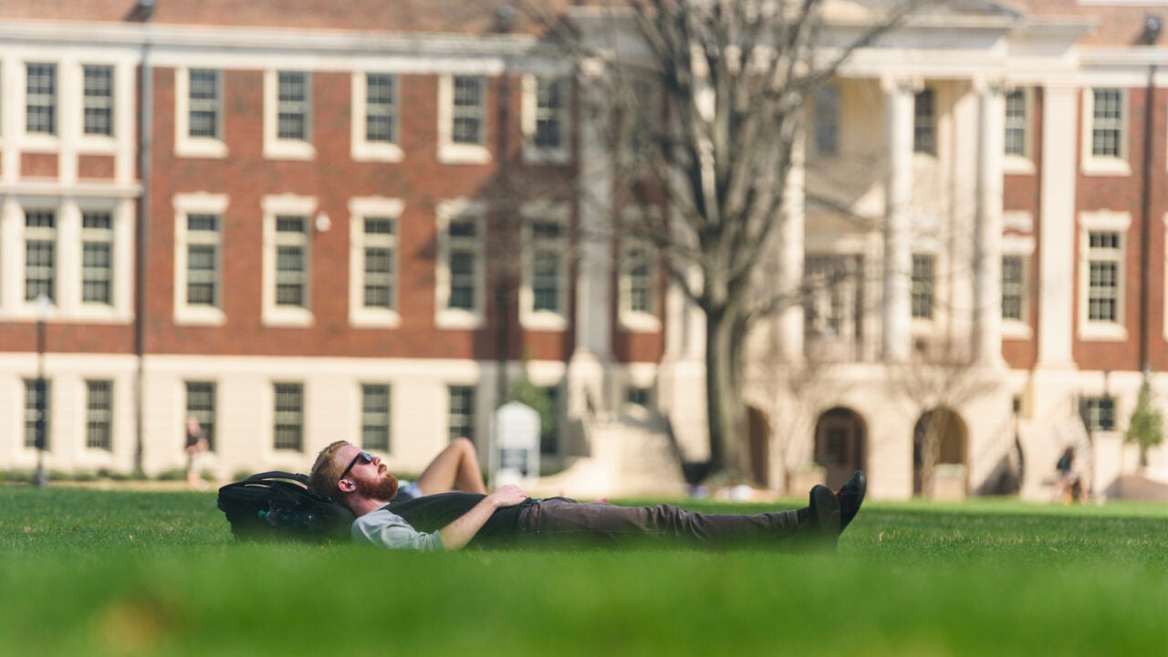 A student taking a nap on the Quad