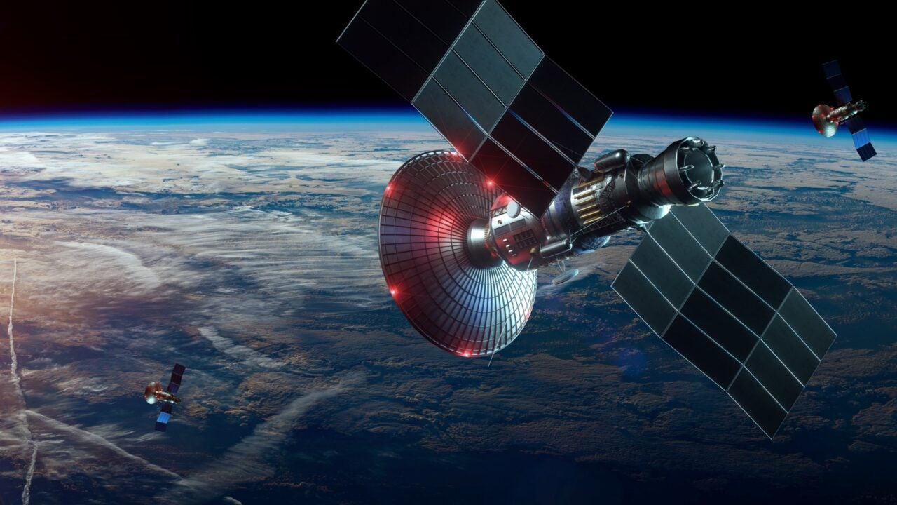 Multiple satellites are shown in orbit over the earth