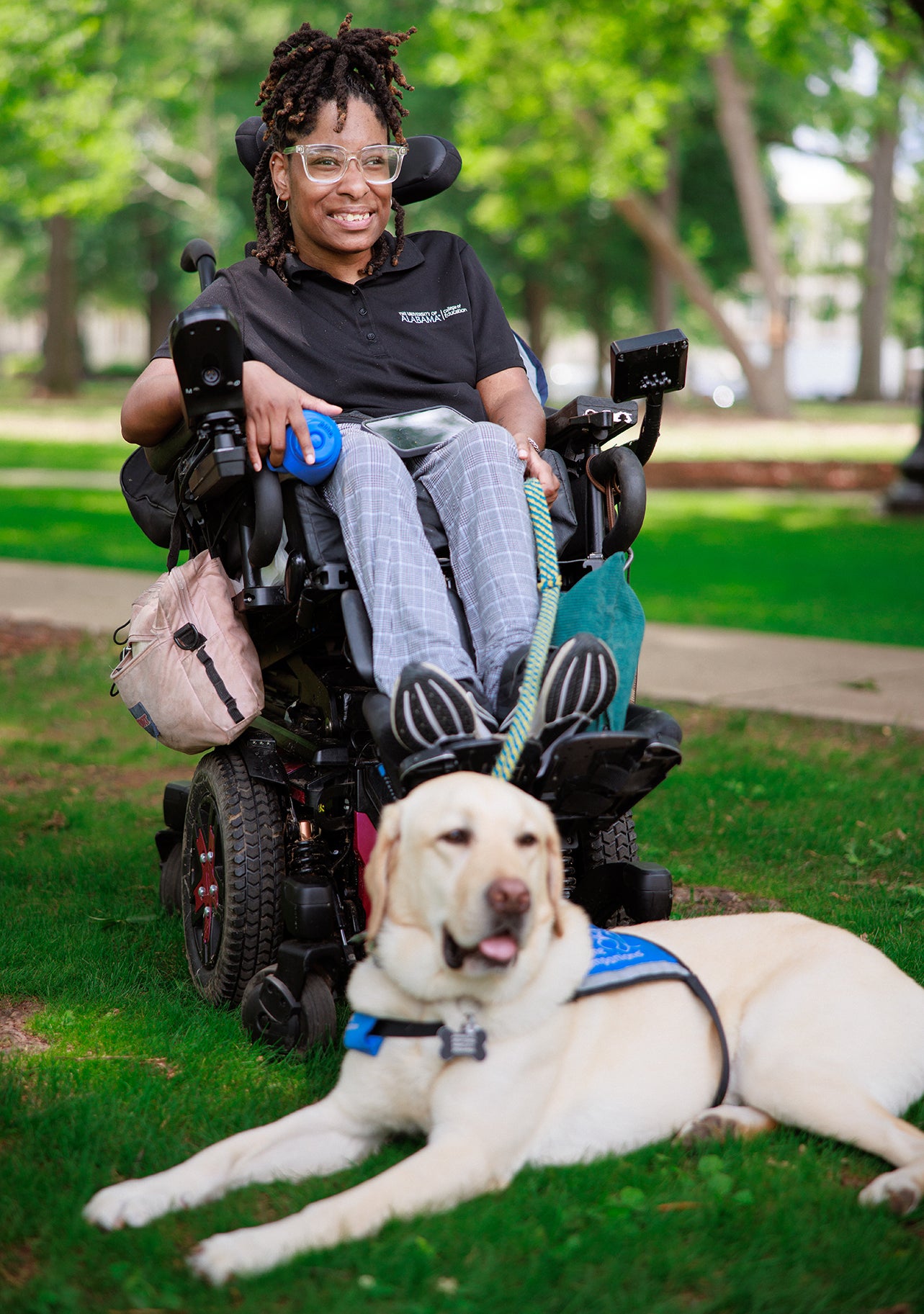 Jamaica Cooper and her service animal Getty, a yellow lab.