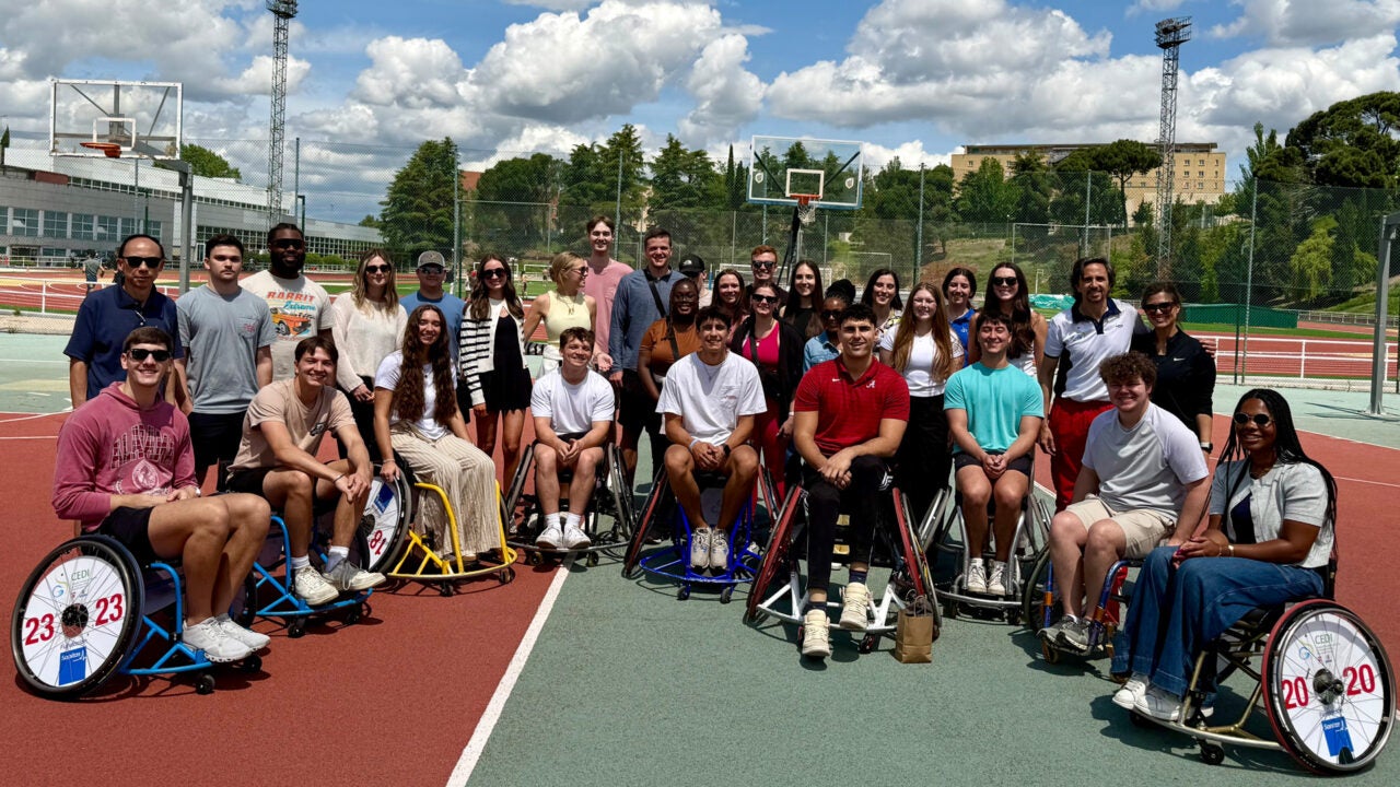 The group of Alabama students with several wheelchair basketball players
