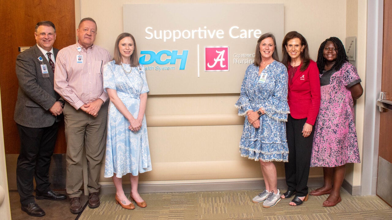 DCH and Capstone College of Nursing staff in front of the Supportive Care Clinic sign