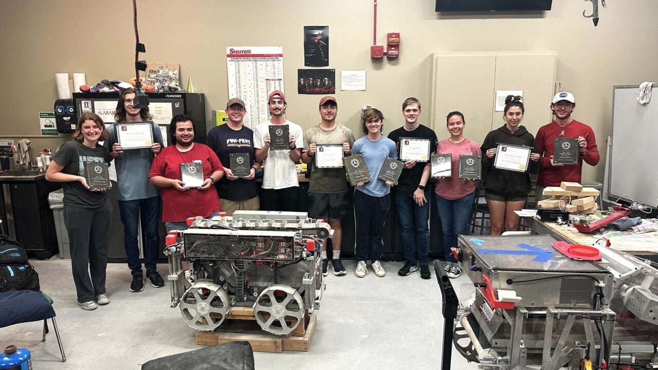 Members of the Alabama Astrobotics travel team stand together in the UA lunar robotics lab