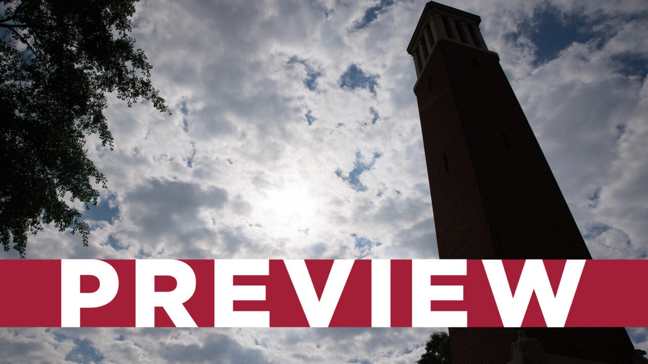 Looking up at Denny Chimes with a cloudy sky in the background