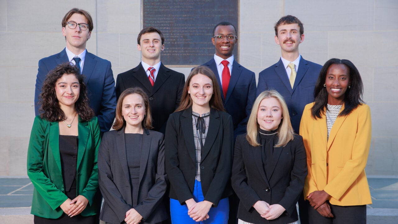 group of nine capitol scholars standing in front of Denny Chimes