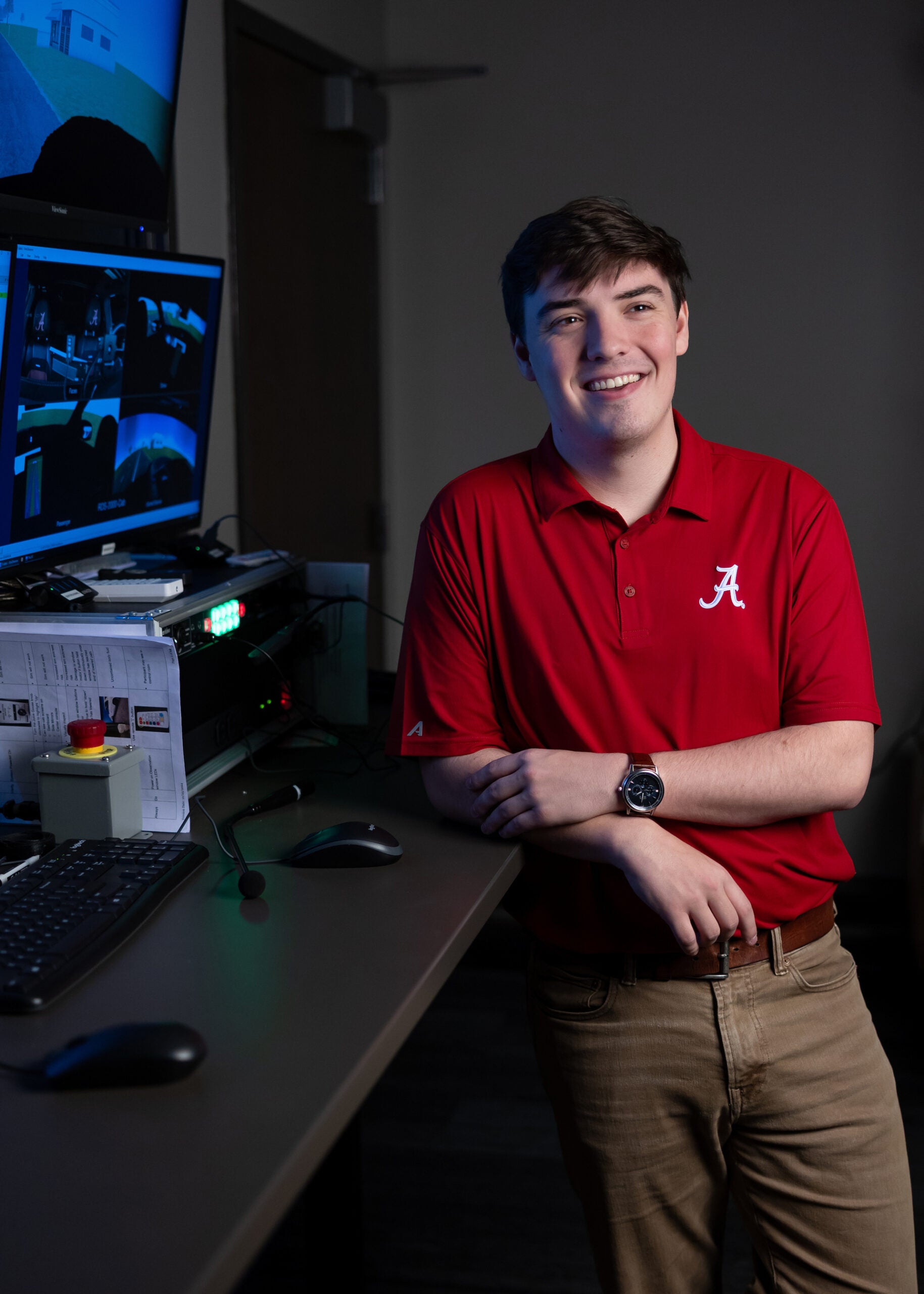 Price Ledbetter leans against a desk in a lab