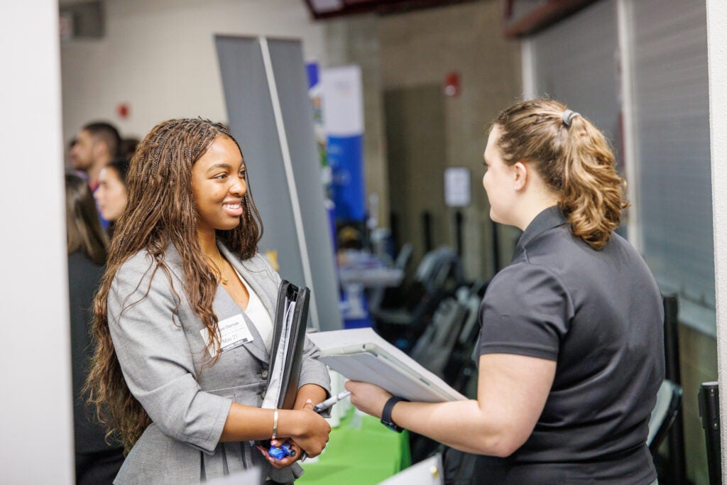 A student networking with a recruiter