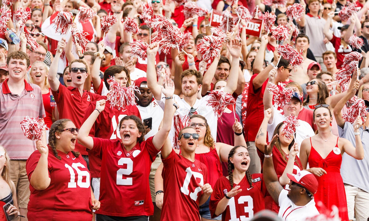 Fans at a UA football game cheering.