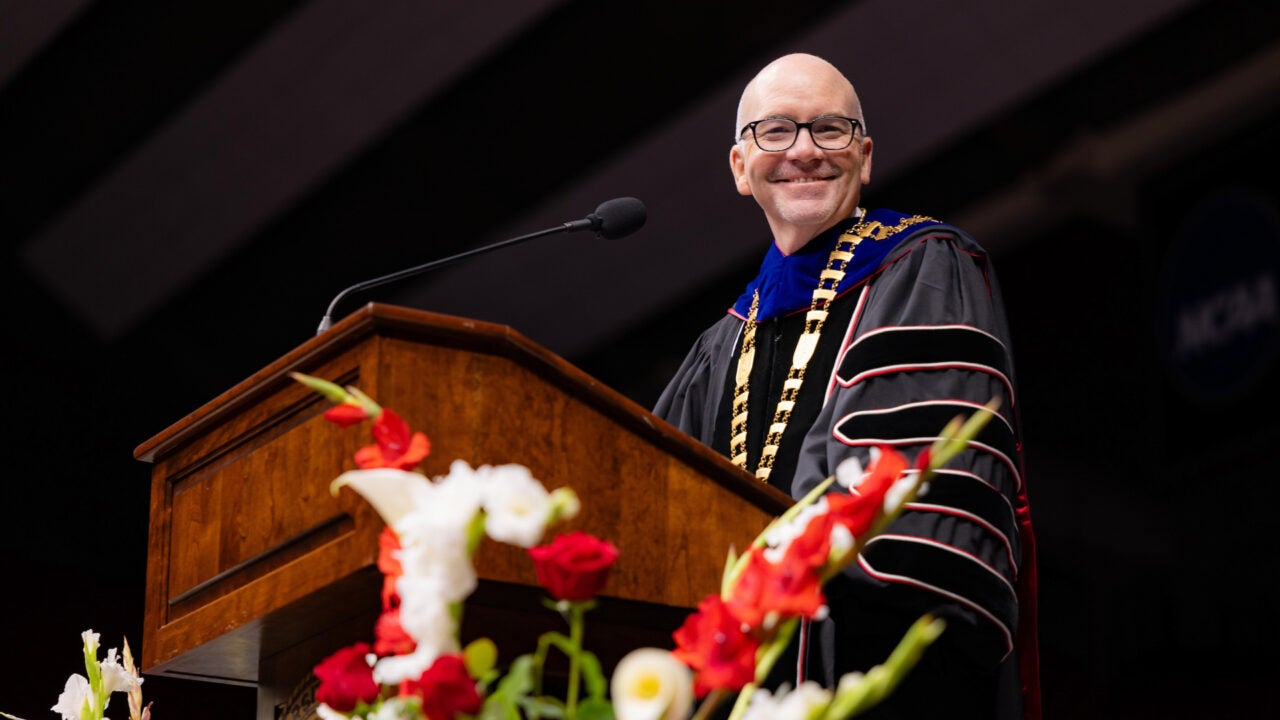 UA President Peter J. Mohler speaks at the podium during commencement