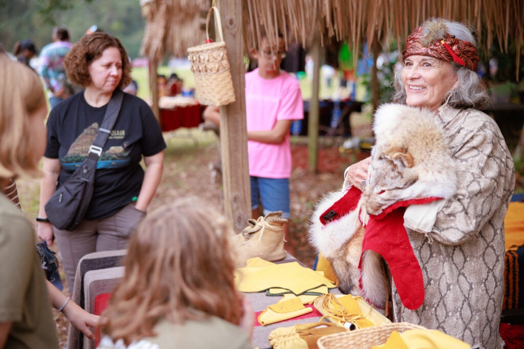 A woman sharing her culture at the Native American Festival