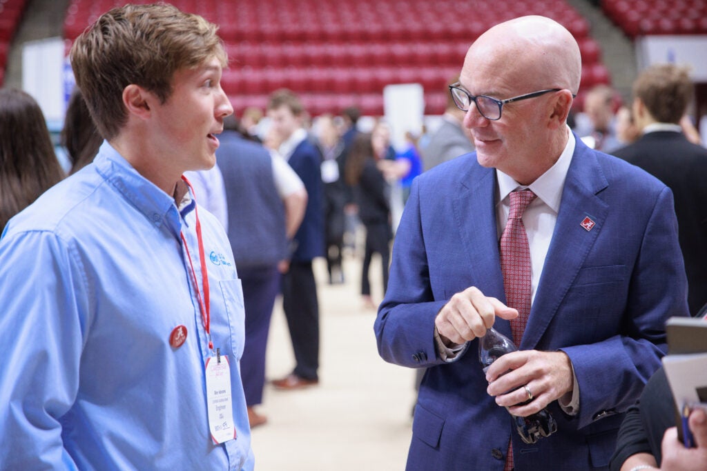 University President talking to student