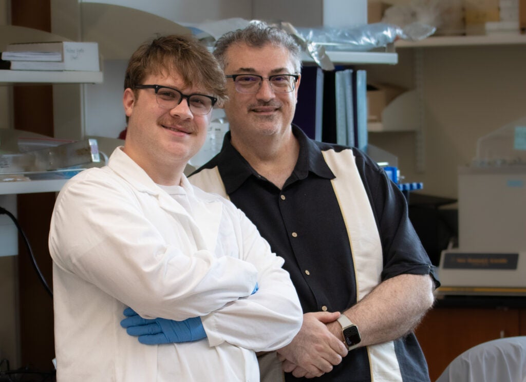 Aidan Meyers and Dr. Guy Caldwell in the Caldwell Lab, also called the "Worm Shack."