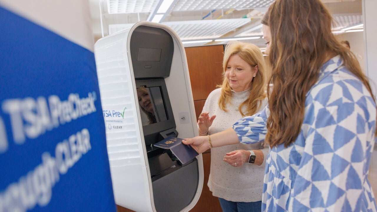 a woman helps a customer get their TSA precheck validated